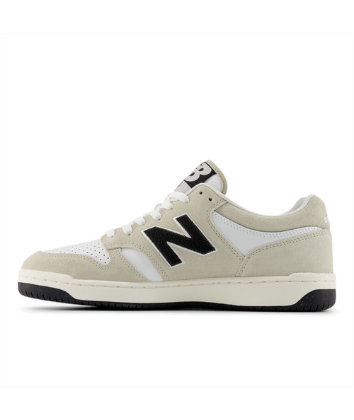 New Balance 480 sneakers in white and beige suede with black logo, side view.