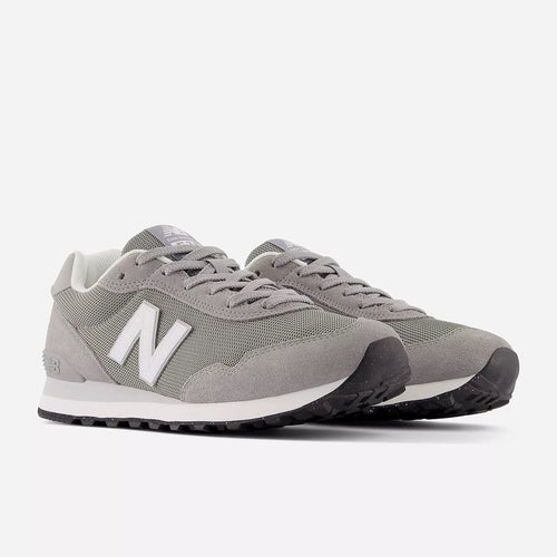 New Balance 515 v3 sneakers in gray with suede and mesh upper, white midsole, and black rubber outsole, angled front view.