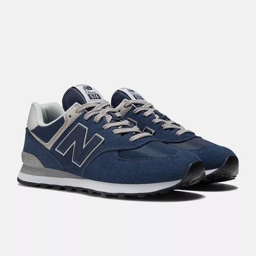 New Balance 574 Core sneakers in navy suede and mesh with gray accents and lace-up closure, angled front view.