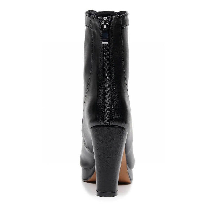 Aadijay by Bailaqui: A sleek black high-heeled ankle boot in vegan leather with a rear zipper, displayed against a white background.