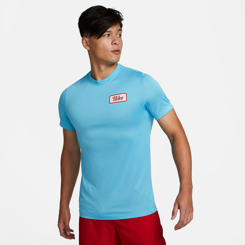 Nike Dri-FIT Fitness T-Shirt in light blue with a red Nike logo on the chest, front view.