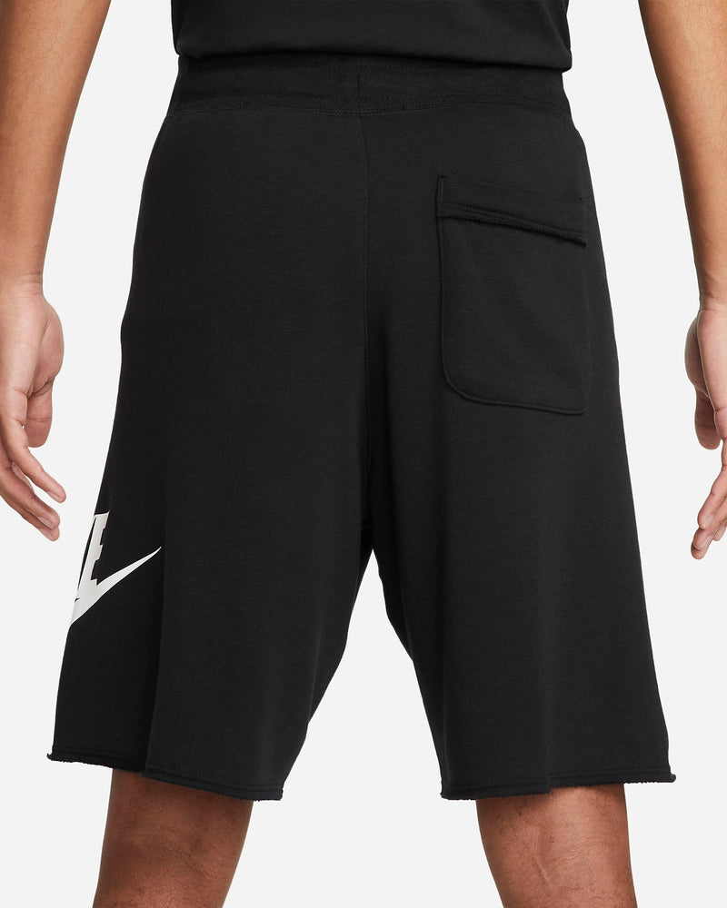 Nike French Terry Alumni Shorts in black with a raw edge hem, back pocket, and white Nike logo detail, back view.