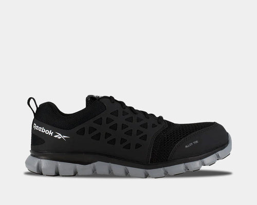 Reebok Work Sublite Cushion Work shoes in black with alloy toe protection, mesh upper, and lightweight gray outsole, side view.