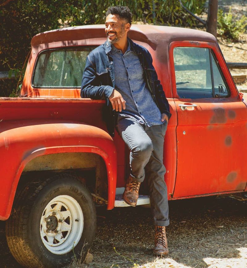 Bed Stu Protege Vintage Finish boots in brown leather with lace-up design and distressed finish, worn outdoors near a red vintage truck.