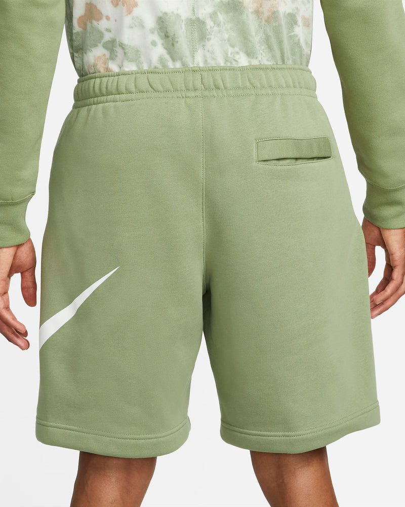 Nike Sportswear Club Shorts in light green with white logo detailing, back view showing elastic waistband and rear pocket.